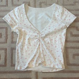 White low cut, short sleeve top with little light pink flowers